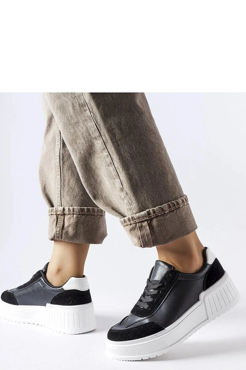 Black sneakers on a thick Seluci platform
